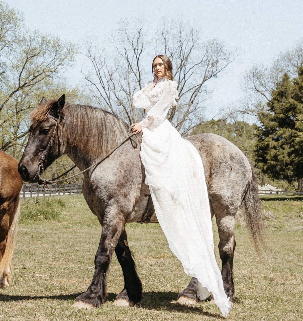 Custom silk bridal gown — custom bridal, USA, by Blár Studio — bride seated on a horse in a spring pasture